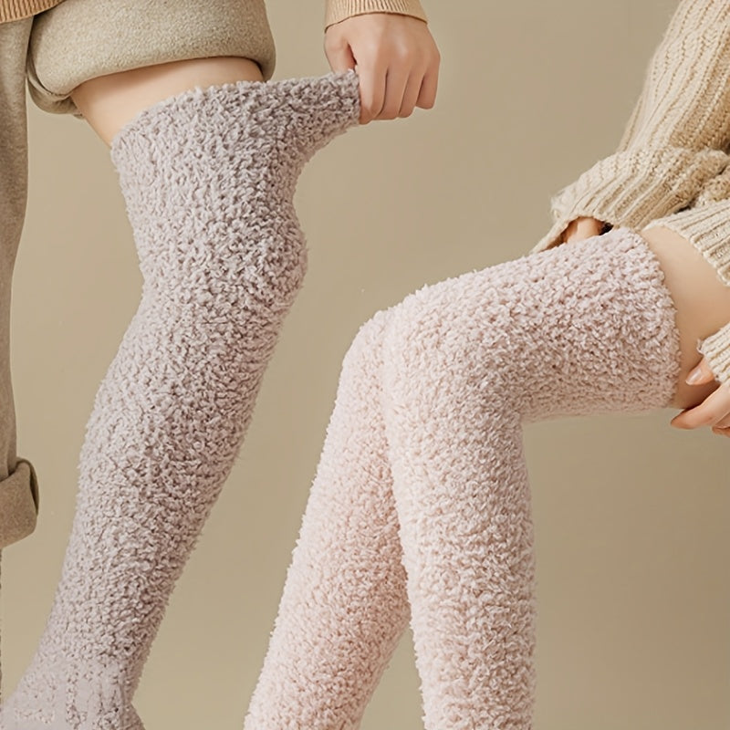 Two models wearing cozy, textured over-the-knee socks in light beige and pale pink, shown against a warm neutral background.